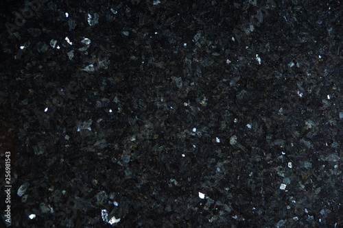 Natural stone of black color with bright sparkles with bluish tint, called labradorite Emerald Pearl