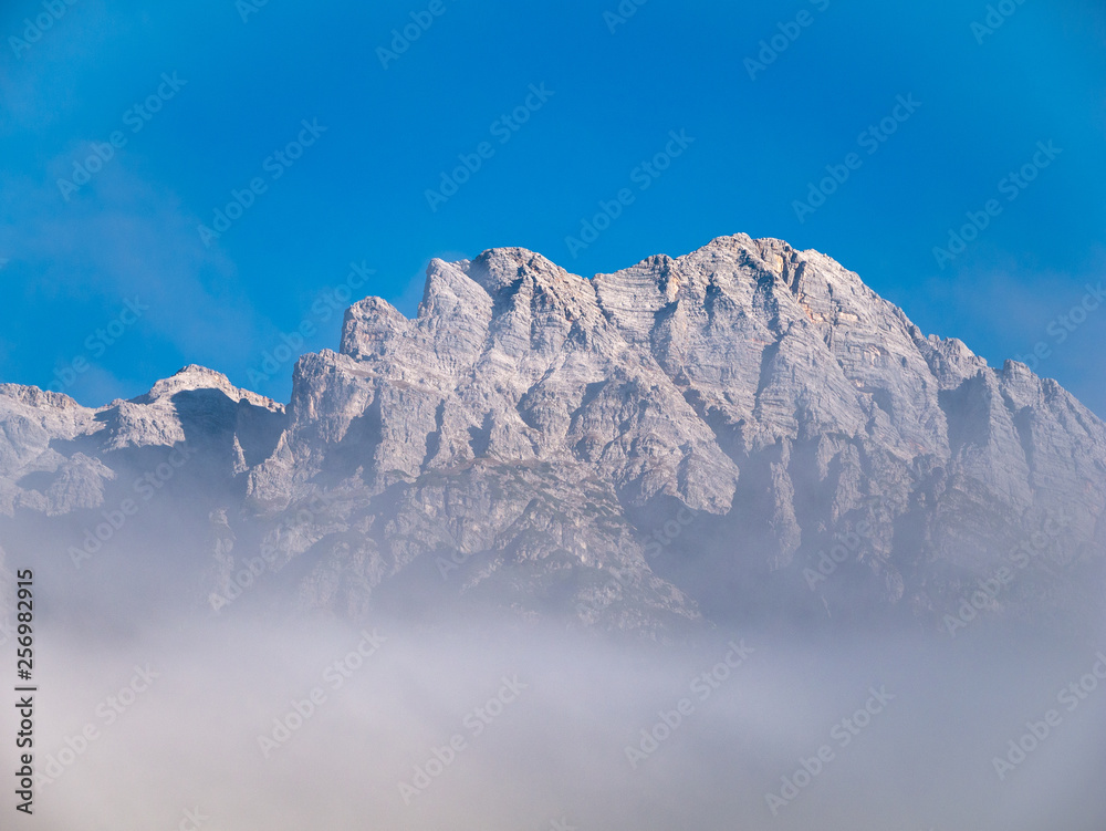image of mountain peak with clouds in the alps