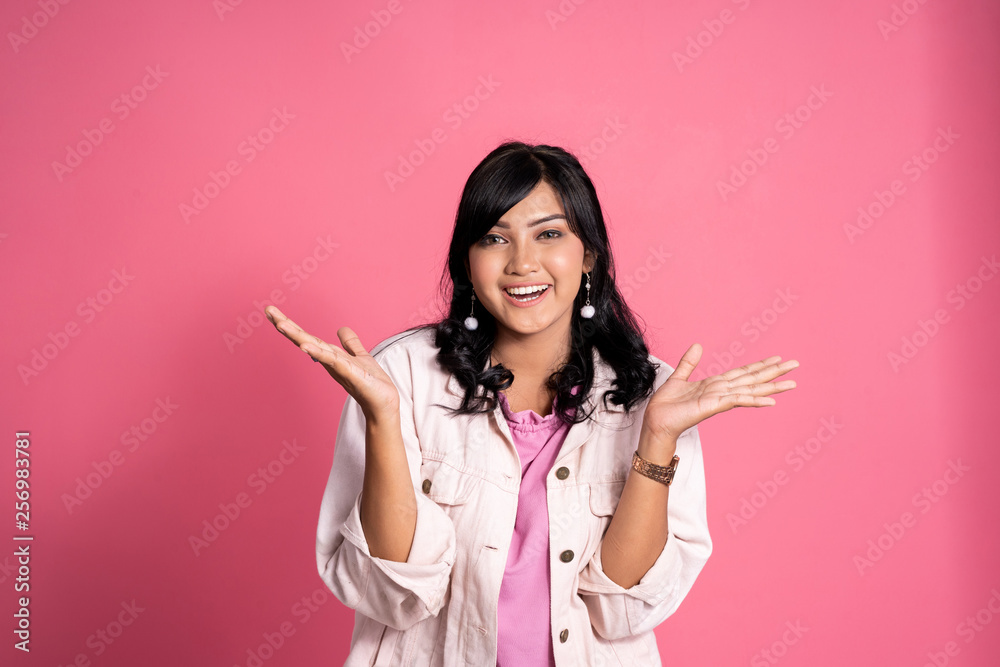 happy excited young asian woman portrait over pink background