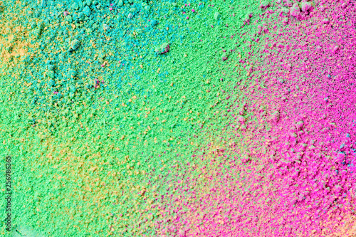 A splatter of pastel natural colored pigment powder on black background. © Pattadis