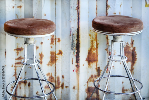 Old two steel chair on rusty zinc wall nobody grey background
