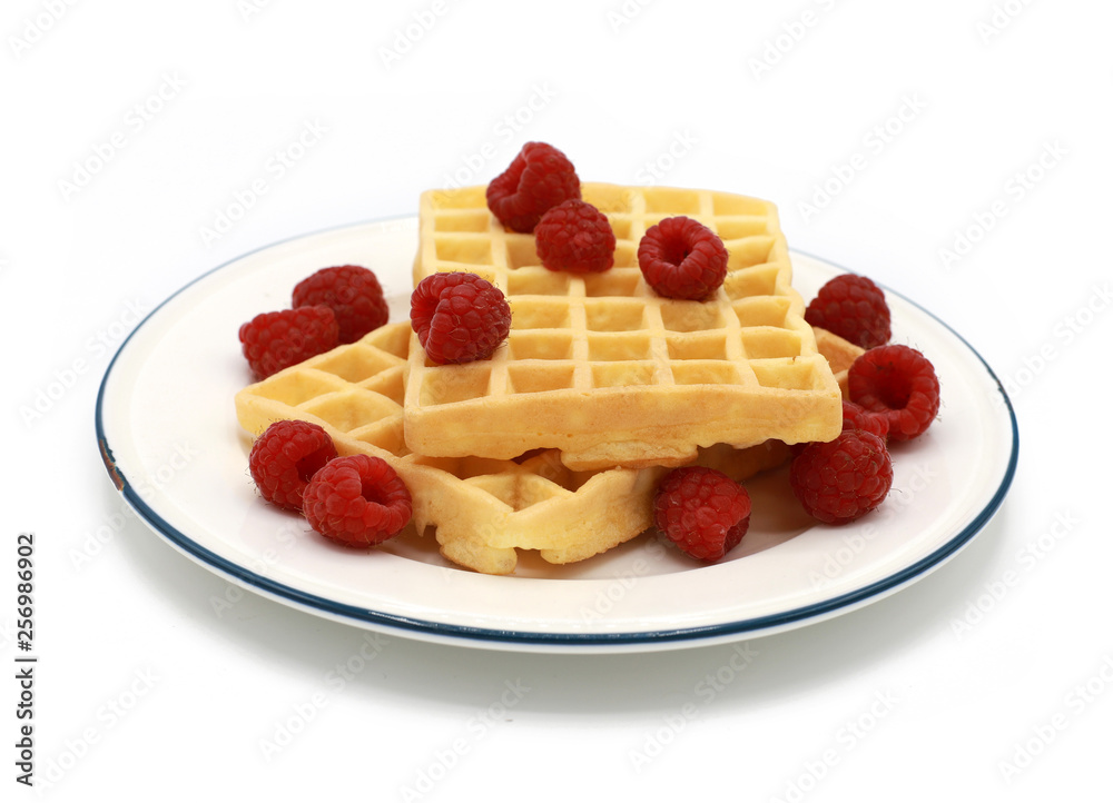 fresh belgian waffles with raspberrys on a plate isolated on white background fresh belgian waffles with raspberrys on a plate isolated on white background