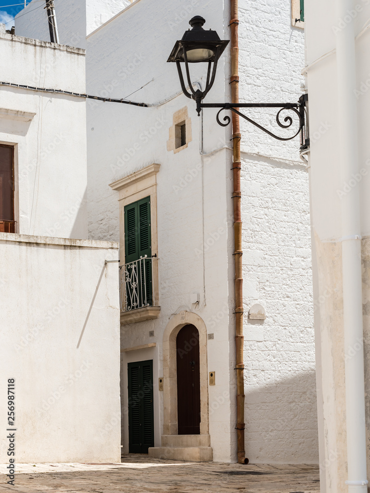 Walking in Locorotondo. Narrow streets and white houses. Dreamlike Puglia, Italy Walking in Locorotondo. Narrow streets and white houses. Dreamlike Puglia, Italy