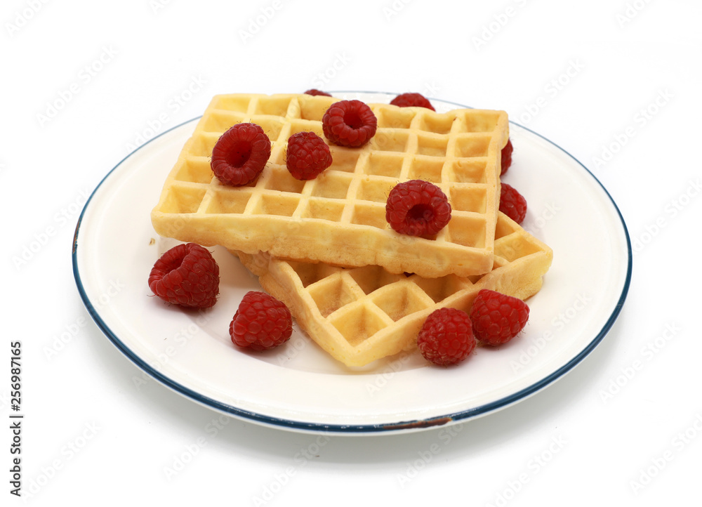 fresh belgian waffles with raspberrys on a plate isolated on white background fresh belgian waffles with raspberrys on a plate isolated on white background