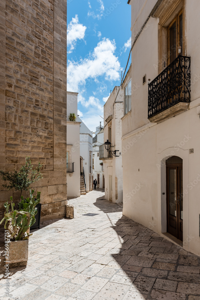 Obraz premium Walking in Locorotondo. Narrow streets and white houses. Dreamlike Puglia, Italy