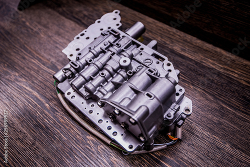 Automatic transmission valve body on wooden background