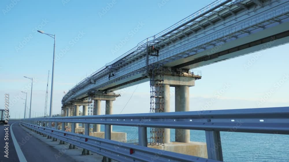 Moving on car on Crimean Bridge between Taman and Kerch with view of construction new rail road above sea. Moving on car on Crimean Bridge between Taman and Kerch with view of construction new rail road above sea.