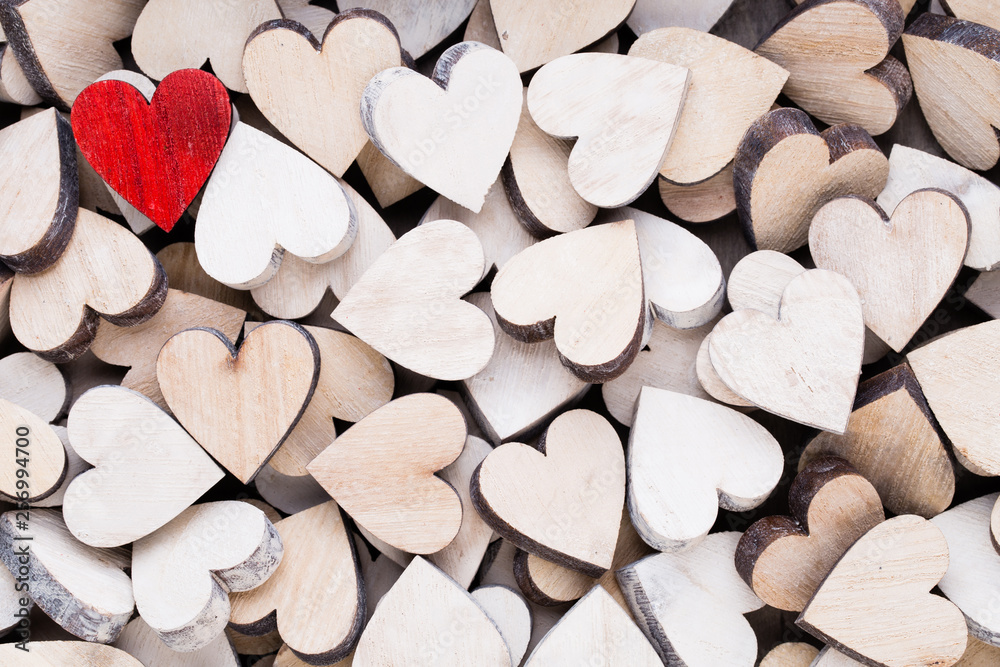 Obraz premium Valentines day background with white end red hearts on wooden background.