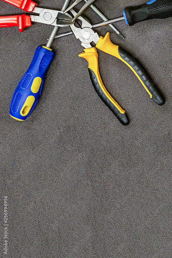 set of hand tools screwdriver with blue rubber handle pliers home repair copy space set of hand tools screwdriver with blue rubber handle pliers home repair copy space