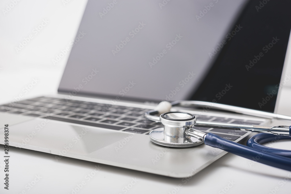 Health stethoscope on keyboard of laptop computer Health stethoscope on keyboard of laptop computer