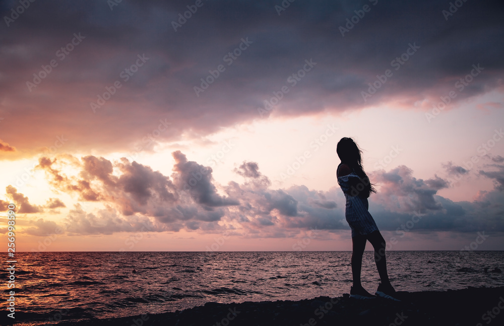 Girl on the beach at sunset.