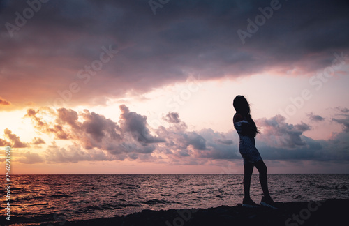Girl on the beach at sunset.