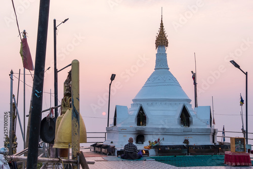 a man pray in front of pagoda, Mulayit Taung, Myanmar photo