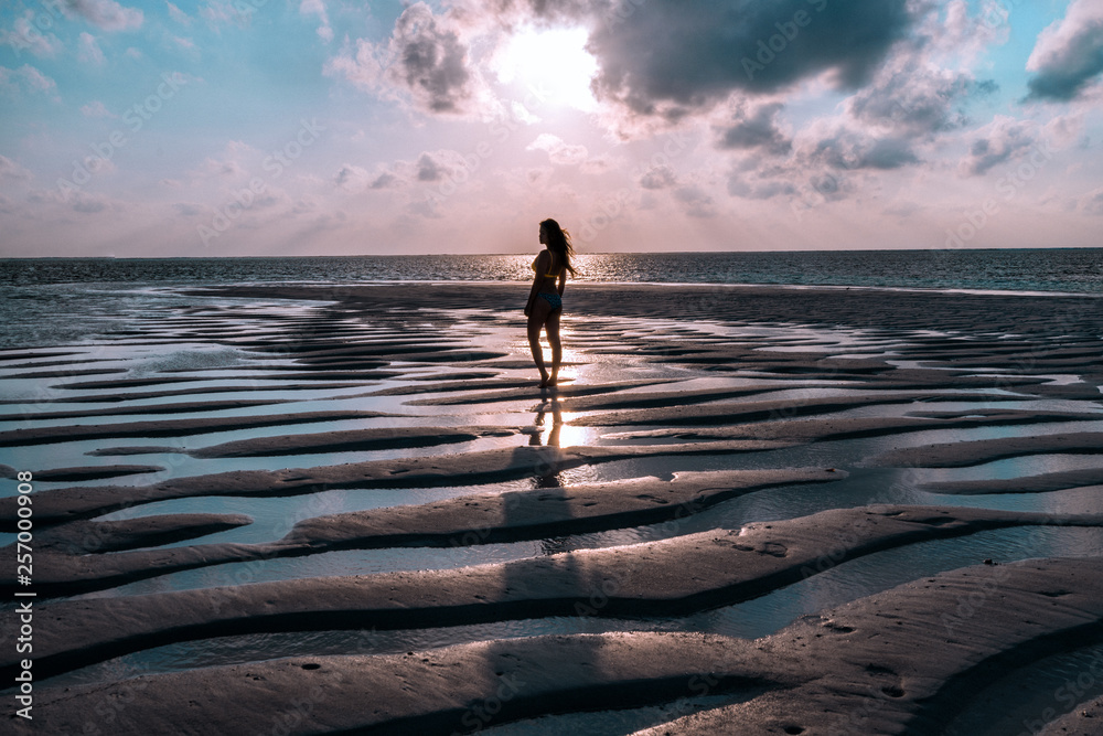 A woman enjoying a sunrise in the Maldives