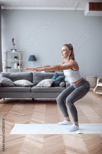 Woman is exercising at home.