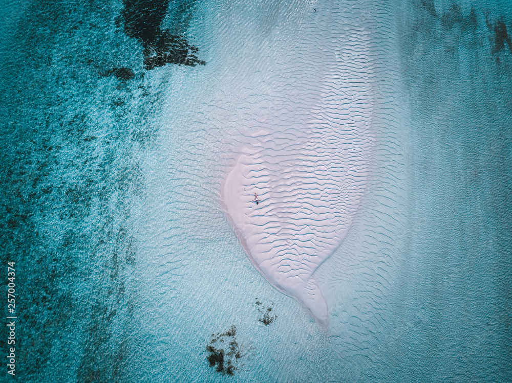 Aerial drone photo - A woman in the Maldives islands.