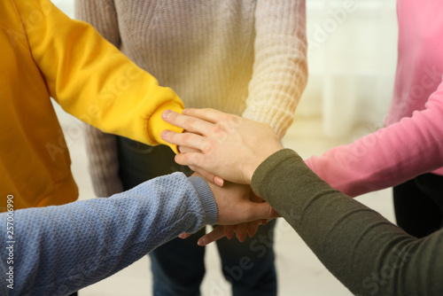 Group of volunteers putting their hands together, closeup