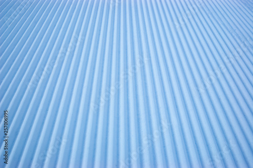 Snow velveteen on an empty ski slope.
