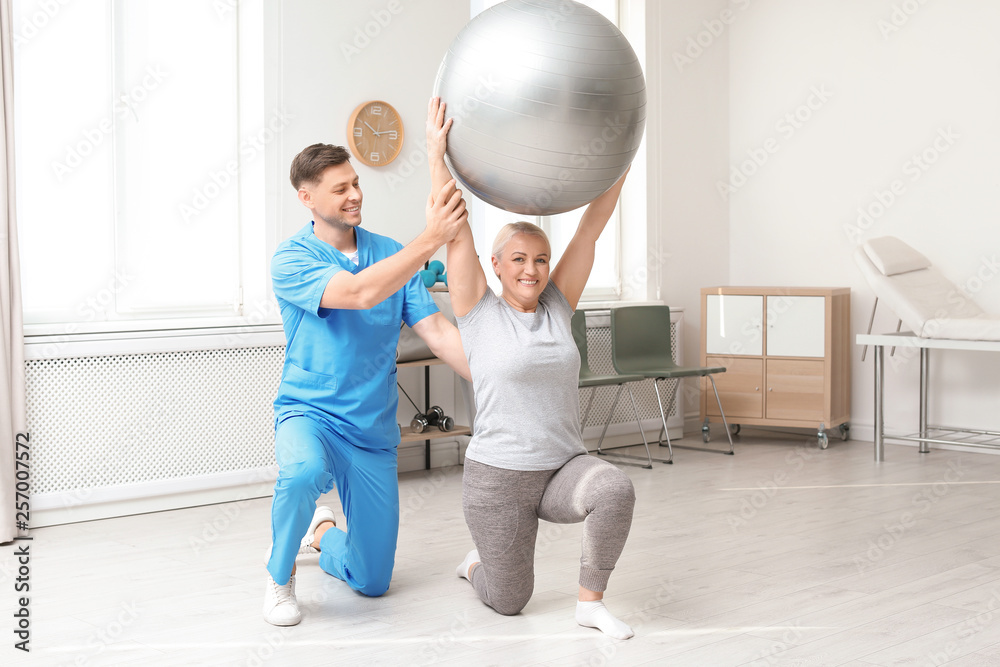 Fototapeta premium Physiotherapist working with patient in clinic. Rehabilitation therapy