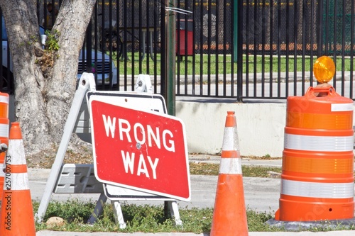Orange traffic cones and Wrong Way Sign,Red background with white letters