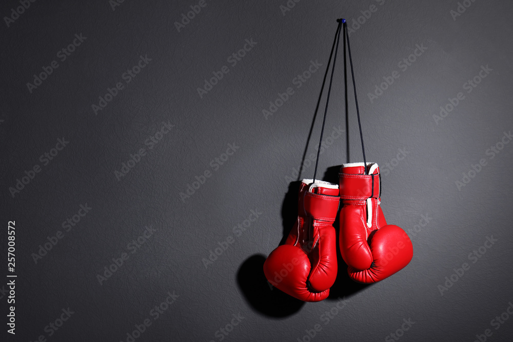 Pair of boxing gloves on grey background, space for text