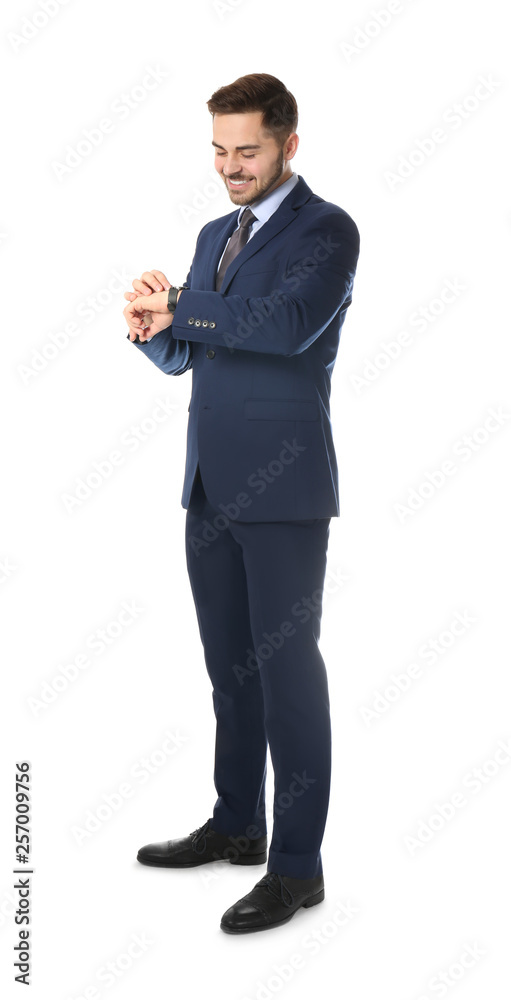 Full length portrait of businessman looking at wrist watch on white background Full length portrait of businessman looking at wrist watch on white background