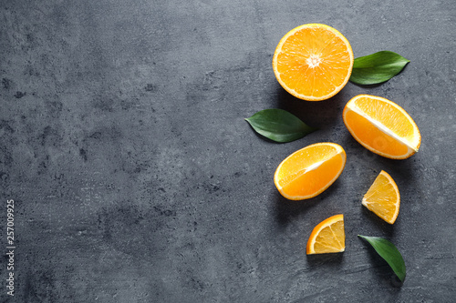 Flat lay composition with fresh oranges on grey background. Space for text