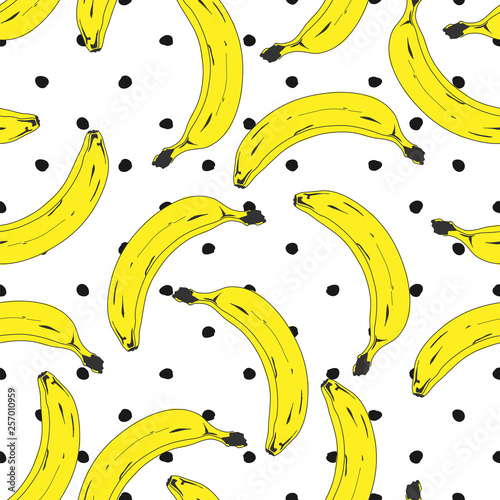 Seamless pop art banana pattern randomly distributed on color background.