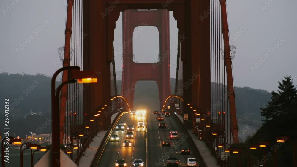 Beautiful view of late evening car traffic street lights on iconic Golden Gate bridge in San Francisco USA after sunset.