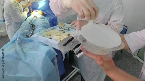 Breast implant. Surgical breast augmentation. Installation of a breast implant. Breast augmentation surgery in the operating room surgeon tools implant. 