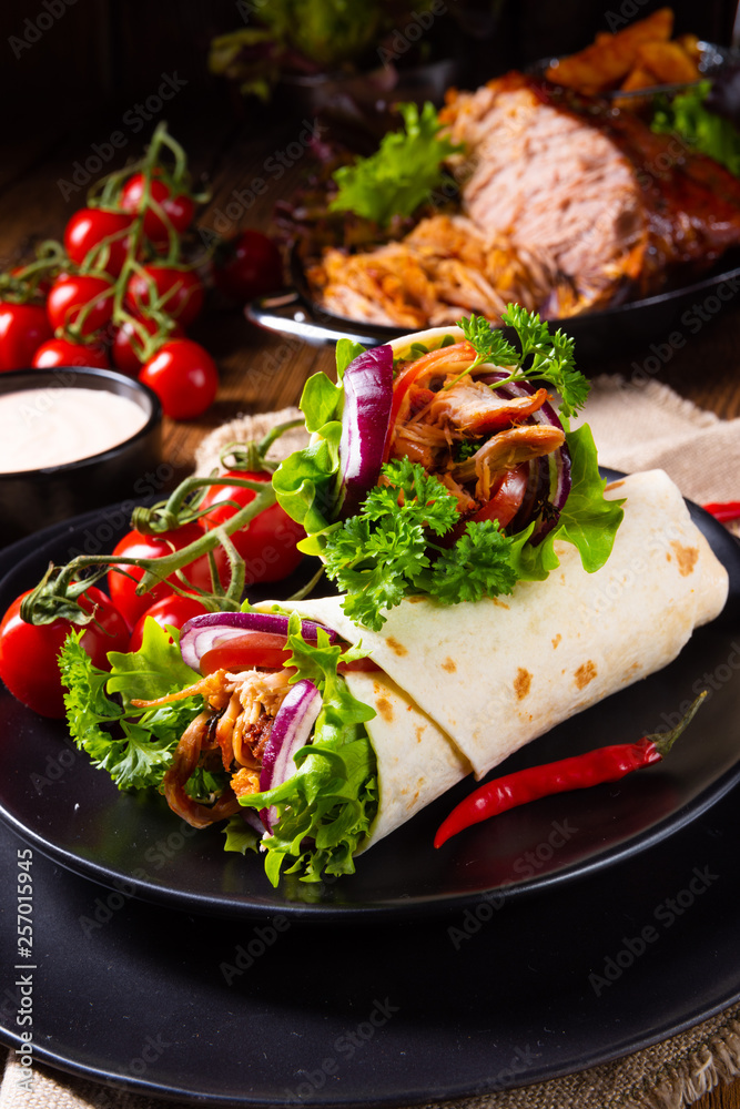 Tasty wraps filled with pulled pork and salad Tasty wraps filled with pulled pork and salad