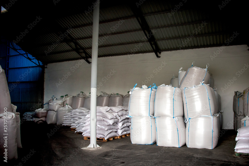 Abstract agrarian image with bags of grain in the agricultural sector in the farm. (good harvest, abundance - concept)