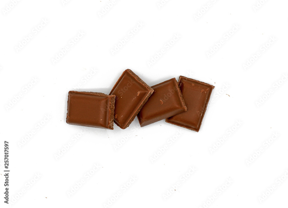 Fototapeta premium Milk chocolate pieces - isolated on white