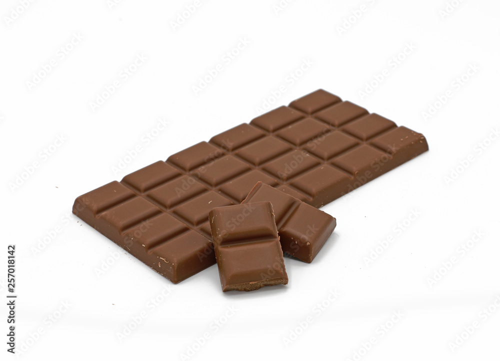 Milk chocolate bar and chocolate pieces isolated on white background Milk chocolate bar and chocolate pieces isolated on white background
