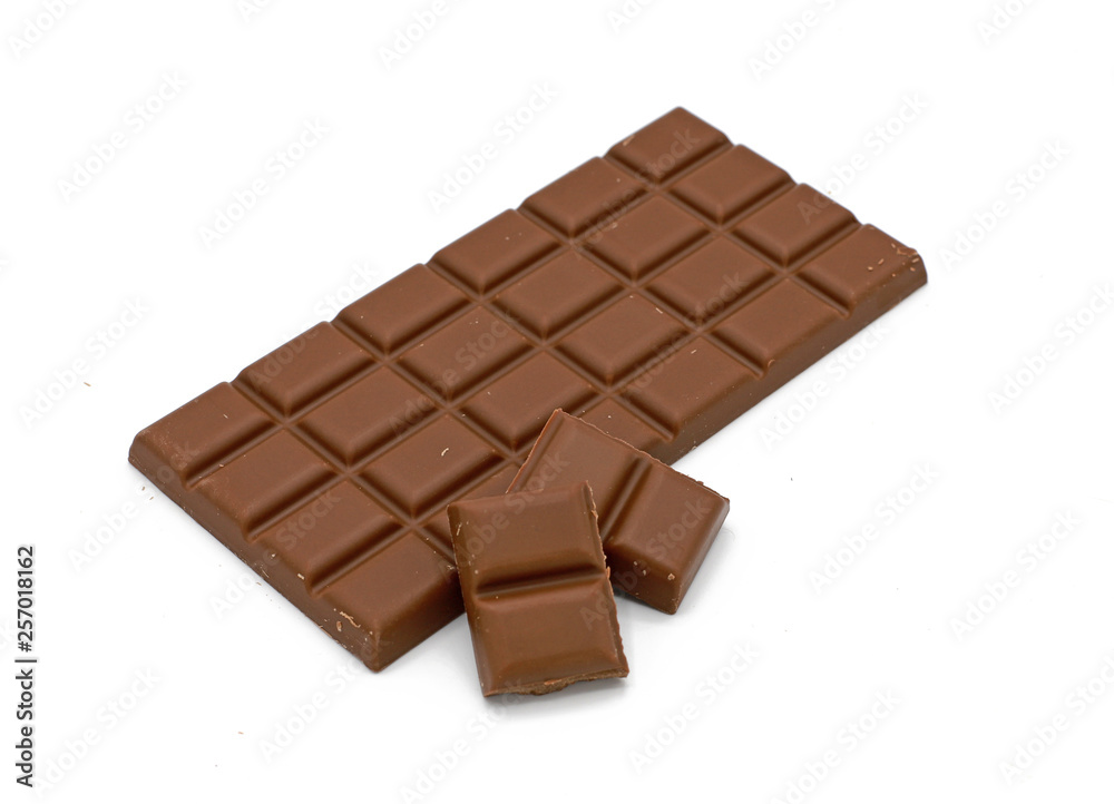 Milk chocolate bar and chocolate pieces isolated on white background Milk chocolate bar and chocolate pieces isolated on white background
