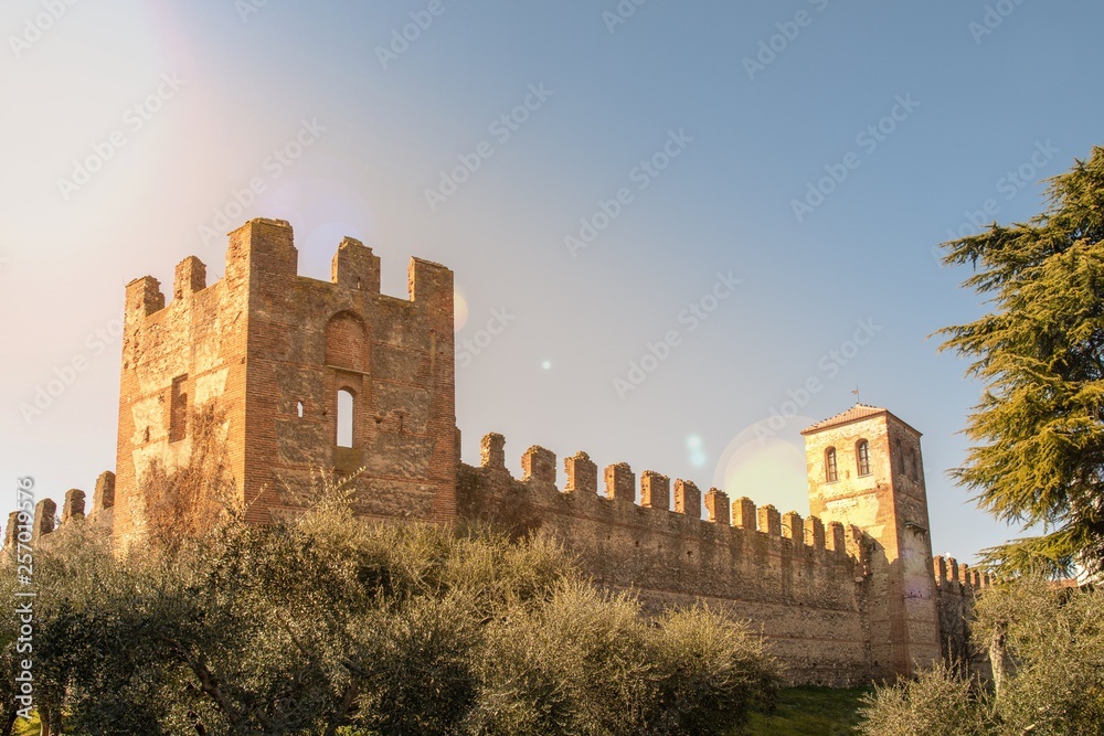 The town walls that surround Lazise, a village on the shore of Lake Garda, with sunlight reflections, Veneto, Italy