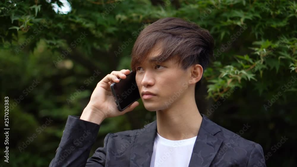 Young Asian Man Talkin on Smartphone Young Asian Man Talkin on Smartphone