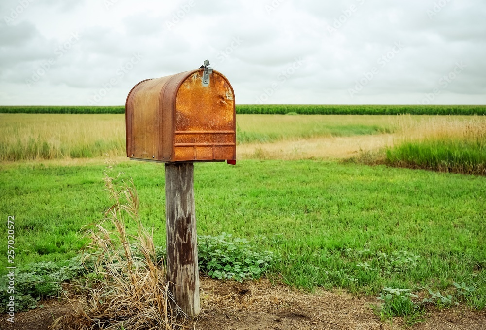 An old rusty mailbox in a field. Stock Photo | Adobe Stock