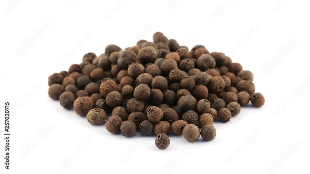Pile of allspice berries rotating on white background - allspice berries are used as seasoning in the kitchen Pile of allspice berries rotating on white background - allspice berries are used as seasoning in the kitchen