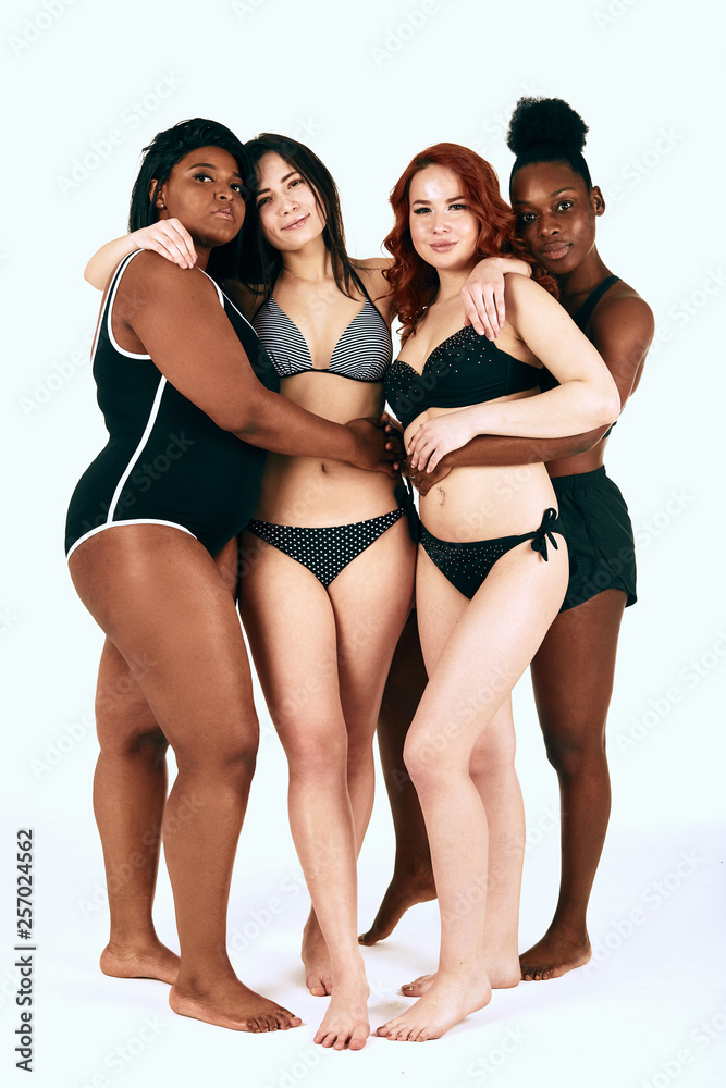 Multiethnic diverse women with cheerful expression smiling and hugging  together, stand in group, dressed in underwear, isolated over white  background. Interracial lesbian couple. Stock Photo | Adobe Stock
