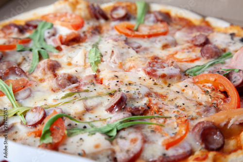  Delicious round pizza with vegetables and ham.