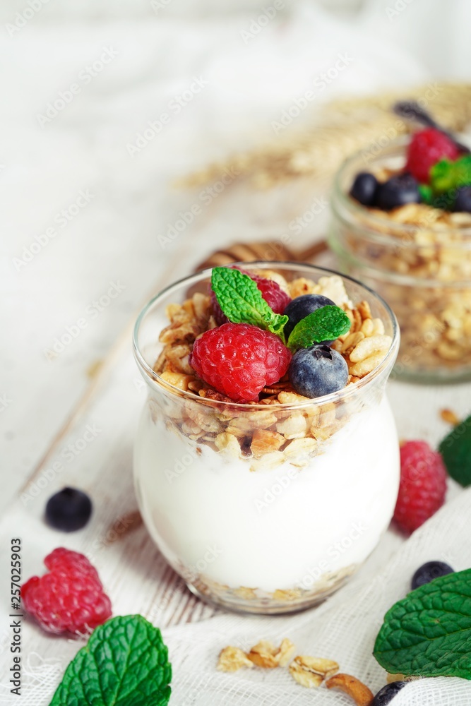 Healthy Breakfast Granola Yogurt Parfait with fresh fruits and berries, selective focus Healthy Breakfast Granola Yogurt Parfait with fresh fruits and berries, selective focus