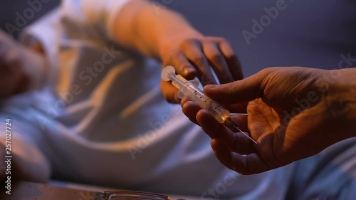 Man hand giving syringe with amphetamine drug, harmful addiction, death habit photo