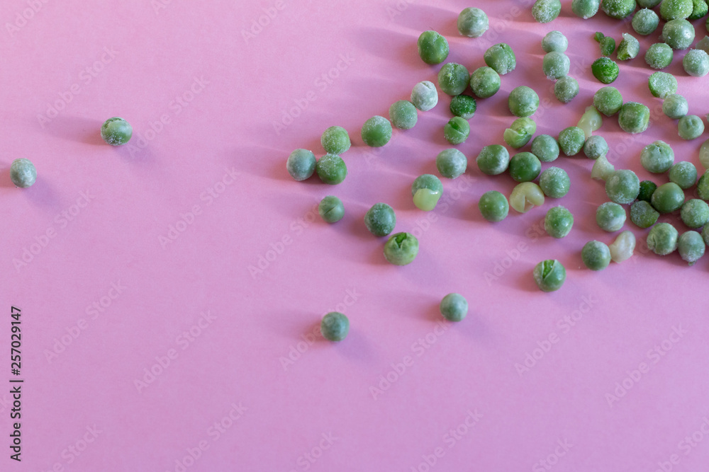 Frozen peas on pink background Frozen peas on pink background