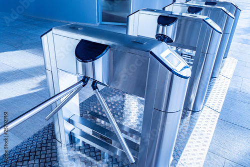 Turnstiles. Checkpoint. Automatic access control. Access system in the building. Automatic turnstile with sliding doors to control the flow of people. Entrance hall with turnstile photo