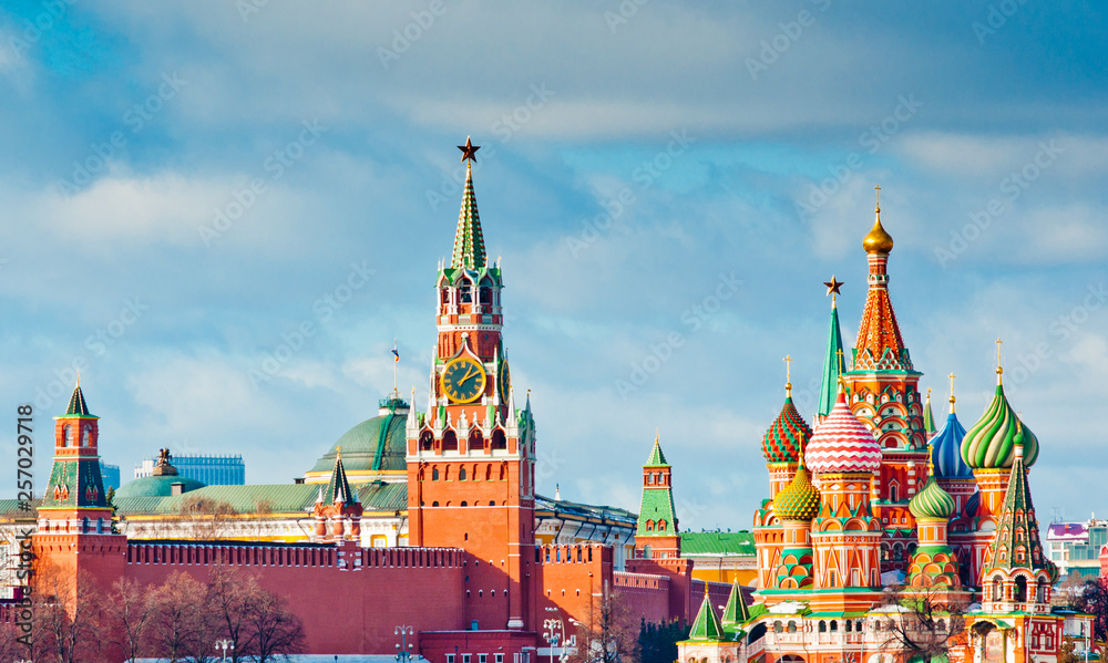 Moscow Kremlin view. Spasskaya Tower  and the Cathedral of Vasily the Blessed (Saint Basil's Cathedral) on Red Square. Sunny winter day. Moscow. Russia