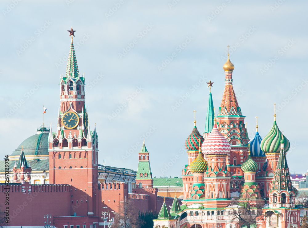 Spasskaya Tower of Moscow Kremlin and the Cathedral of Vasily the Blessed (Saint Basil's Cathedral) on Red Square. Sunny winter day. Moscow. Russia Spasskaya Tower of Moscow Kremlin and the Cathedral of Vasily the Blessed (Saint Basil's Cathedral) on Red Square. Sunny winter day. Moscow. Russia