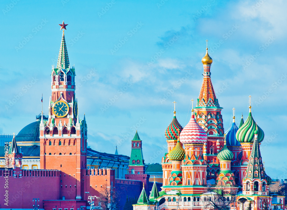 Spasskaya Tower of Moscow Kremlin and the Cathedral of Vasily the Blessed (Saint Basil's Cathedral) on Red Square. Sunny winter day. Moscow. Russia Spasskaya Tower of Moscow Kremlin and the Cathedral of Vasily the Blessed (Saint Basil's Cathedral) on Red Square. Sunny winter day. Moscow. Russia