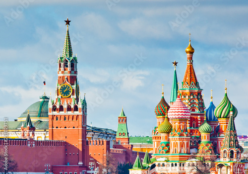 Spasskaya Tower of Moscow Kremlin and the Cathedral of Vasily the Blessed (Saint Basil's Cathedral) on Red Square. Sunny winter day. Moscow. Russia