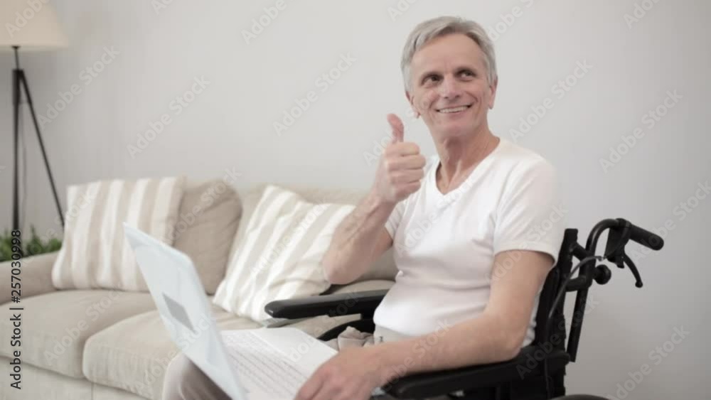 Disabled man in wheelchair using laptop at hospital Disabled man in wheelchair using laptop at hospital